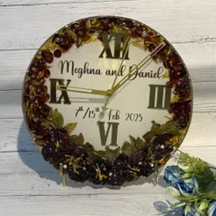 A classic wedding preservation clock. This piece features the couple's names and wedding date, with a full border of their preserved varmala flowers, creating a timeless and personal memento.
