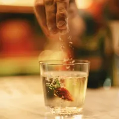 A final touch of salt on a unique cocktail featuring Byadgi chilli. This close-up captures the detail and innovation that our guest mixologists bring to the bar.