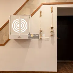 This compact, wall-mounted pooja unit features a beautiful backlit circular design. Placed next to the entryway, it creates a divine and welcoming ambiance right from the entrance of the home.