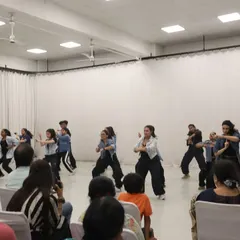 The power of a team. Students performing a dynamic hip hop choreography piece during the showcase, demonstrating the skills and confidence they built during the intensive program.