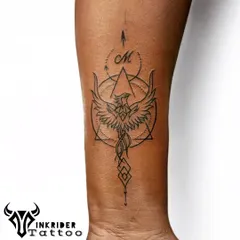 A geometric phoenix design incorporating triangles, circles, and the client's initial. This is a perfect example of how we blend sacred geometry with personal symbols.