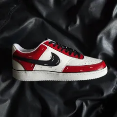 A side profile of the red cartoon custom sneaker on a black background.