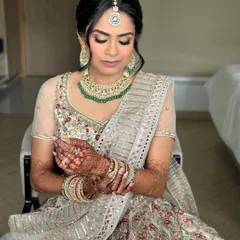 A quiet moment before the ceremony. The soft glam makeup looks flawless, with flushed lids and a luminous base that will last from 'I do' to the final dance.