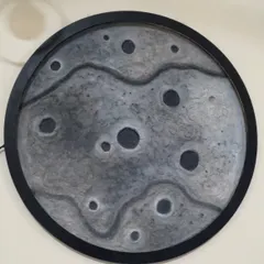 A different design for the moon lamp, this one with a black frame and a more subtle, wavy texture across the surface.