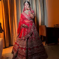 Here you can see the complete traditional bridal look. The makeup is balanced to harmonize with the heavy embroidery of the lehenga and the intricate jewelry, ensuring the bride herself remains the focus.