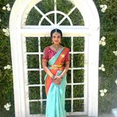 Another beautiful shot of the same look, showing how the makeup enhances her features and gives her a polished, celebratory appearance.
