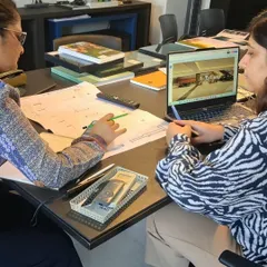 From plans on paper to visuals on screen, every project is a story of many minds at work. This image captures a moment of collaboration, where team members review architectural drawings and digital renders together to fine-tune every detail.