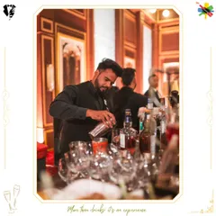 A moment of intense focus as our bartender crafts a drink. This image captures the precision and dedication that goes into every single cocktail we serve.