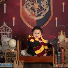 Wingardium Leviosa! We can bring a little magic to your baby's photoshoot with a fun theme like this Harry Potter setup. It's all about capturing their budding personality in a creative way.