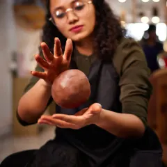 An instructor playfully levitates a ball of clay, channeling her creative energy. Our studio is a place of passion, fun, and a little bit of magic.