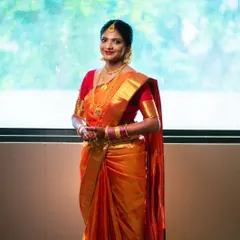 A traditional bride who loves to keep it simple and elegant. This look focuses on clean makeup that enhances her features, allowing her beautiful orange Kanjeevaram saree and radiant smile to take center stage.