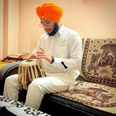 Seated and ready for 'riyaaz' or practice. The journey of a musician is built on these countless hours of dedicated effort.