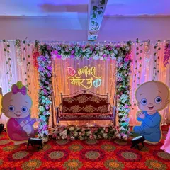 This is a popular 'Boy or Girl' themed setup with large baby cutouts, a decorated jhula, and beautiful lighting.