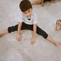 Winners are not born, they are made through hard work. This young student is working on his flexibility with a straddle stretch.