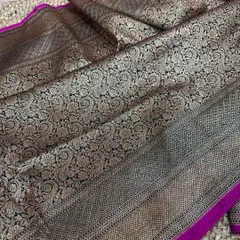 Check out the complete look of this black and magenta Banarasi silk saree. The antique gold zari jaal work covers the entire pallu, creating a luxurious effect.