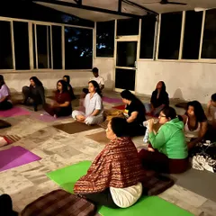 An evening meditation session at our Rishikesh retreat. As the sun sets, we gather to turn our focus inward, guided by the peaceful energy of the surroundings.