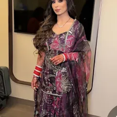 A full-length shot showing how the makeup complements the intricate purple and silver outfit. The glamorous makeup completes this perfect party look.