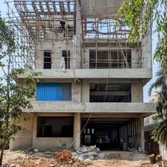 The same Ulwe bungalow during the construction phase. This image demonstrates the translation of the 3D design into a physical structure, showcasing the concrete shell and scaffolding as the architectural vision takes shape.