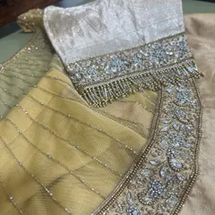 A detailed shot of a sleeve featuring intricate crystal, bead, and tassel work. This level of detail is what defines our commitment to craftsmanship.