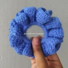 A close-up of the blue crochet scrunchie, showing the ruffles and texture. All our scrunchies are washable and made to last.