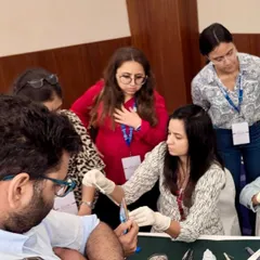 I believe in the power of shared knowledge. Here, I am leading a hands-on workshop at the Aesthetics 2024 conference, demonstrating a technique to fellow dermatologists. Teaching is a passion that sharpens my own skills.