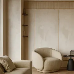 Textural details are key to creating warmth. Here, we used subtle wall paneling and a comfortable, curved armchair to create an inviting corner within the larger lounge, proving that luxury is often in the quiet details.