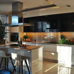 A beautiful open-concept kitchen with a breakfast bar and seating. This design is perfect for modern homes, creating an interactive space for family and guests.