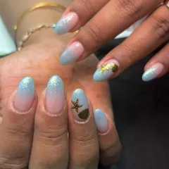 Another view of the beachy nails, showing the soft blend of the blue and nude glitter base.