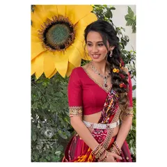 A close-up of Prathima's haldi look. The soft makeup and the intricate, colorful braid create a look that is both beautiful and perfect for a daytime celebration.