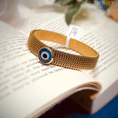 A closer look at one of my Evil Eye bracelets. This design features the protective symbol on a wide, textured gold-plated mesh band, offering a bold and fashionable way to wear your belief.