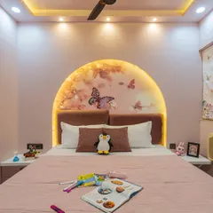 When a client's daughter wanted a pink room, I made sure to create a space she would love. This bedroom features a custom-arched headboard with butterfly wallpaper and soft backlighting, creating a dreamy and magical atmosphere.