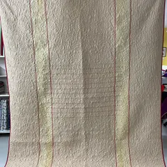 The reverse side of a memory quilt, showing how we use a complementary fabric to create a completely different look. This side features a simple, elegant design that still showcases the intricate longarm stitching.