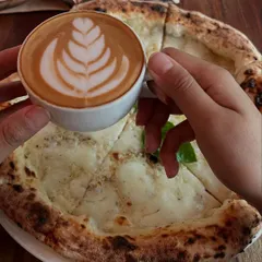 Coffee plus pizza equals a whole lot of love. Our Bianca pizza with a perfectly made cappuccino is an unexpected but amazing pairing.