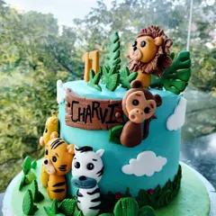 A playful jungle-themed birthday cake designed for a child's party. I love bringing your creative ideas to life with detailed fondant animals and vibrant colours to make any kid's day extra special.