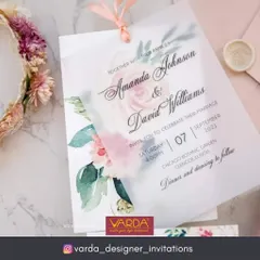 This romantic wedding invitation features a soft watercolor floral design printed on a vellum overlay, layered over the main card. The effect is dreamy and delicate, perfect for a modern yet timeless wedding aesthetic.