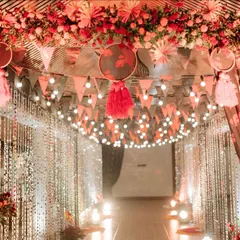 For a bold and passionate theme, I designed this entrance with rich red florals, warm bulb lighting, and shimmering bead curtains. It created a vibrant and celebratory passage into the main event area.