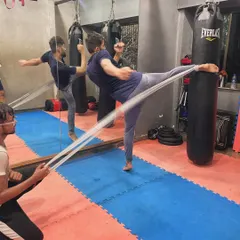 We use tools like resistance bands to build explosive power and control in our kicks. This drill helps improve both strength and flexibility for martial arts.