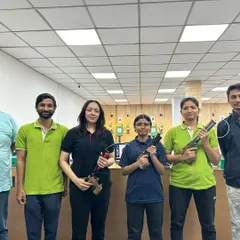 A group of adults after a recreational shooting session, holding both air pistols and air rifles. My sessions are a popular activity for friends and corporate teams looking for a new experience.
