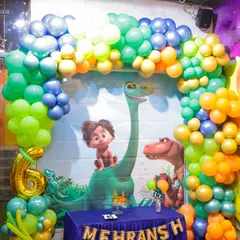 A full view of our dinosaur-themed party setup. We use vibrant balloon arches, character backdrops, and personalized banners to create a prehistoric wonderland for the birthday child and their guests.