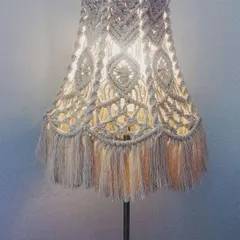 A beautiful macrame lampshade that adds a touch of boho elegance to any standard lamp. The fringe and detailed patterns create a soft, diffused light.