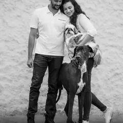 The whole family together. This posed shot shows the couple with their Great Dane and Shih Tzu, creating a beautiful black and white family portrait that includes every member.