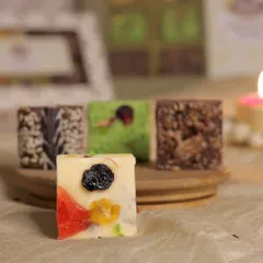 Our Candied Fruit Fudge is a modern take on a classic confection. This close-up shows the colorful bits of candied fruit and nuts embedded in a creamy white chocolate fudge square.