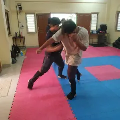 Two students sparring on the mats. This is where they learn to manage distance, timing, and pressure in a live but controlled setting.