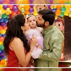 A baby's first birthday is a milestone for the whole family. We focus on capturing these loving, candid family portraits, like this tender kiss from mom and dad, creating a memory that will be cherished for a lifetime.