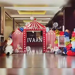 A grand carnival entrance with multiple striped tent archways, creating an impressive and immersive welcome for all the guests.