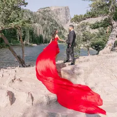 Create unforgettable memories with a pre-wedding photoshoot in one of my signature flying dresses. This couple chose a vibrant red trail gown, which creates a beautiful contrast against the natural mountain landscape.