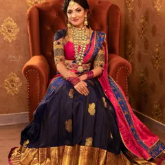 A full view of a grand look for a half-saree ceremony. This rental set includes a stunning coin haram, a choker, and a matching vaddanam, paired with a traditional silk Langa Voni for a truly memorable occasion.