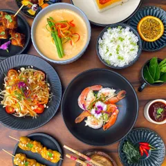 A vibrant spread from our 'Bangkok Joes' Thai menu, featuring classics like Som Tam salad, chicken satay, and coconut-crusted prawns.