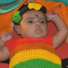 Another adorable baby wearing the crochet rainbow frock. The vibrant stripes look so lovely, and it brings me so much joy to see my creations on these happy little customers.