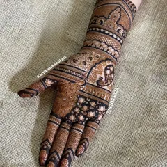 A classic Indian traditional mehandi design. This single-hand pattern features a prominent peacock, lotus motifs, and a beautiful cuff, perfect for any festive occasion.